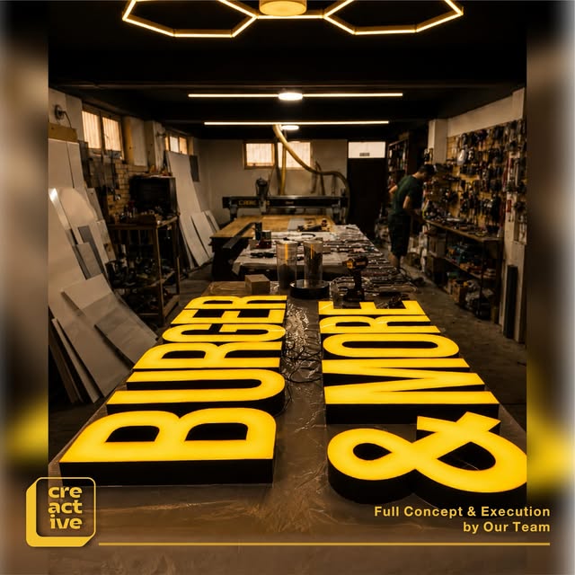 Yellow 3D letters "Burger & More"